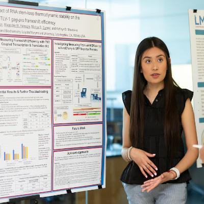 Student next to a research poster